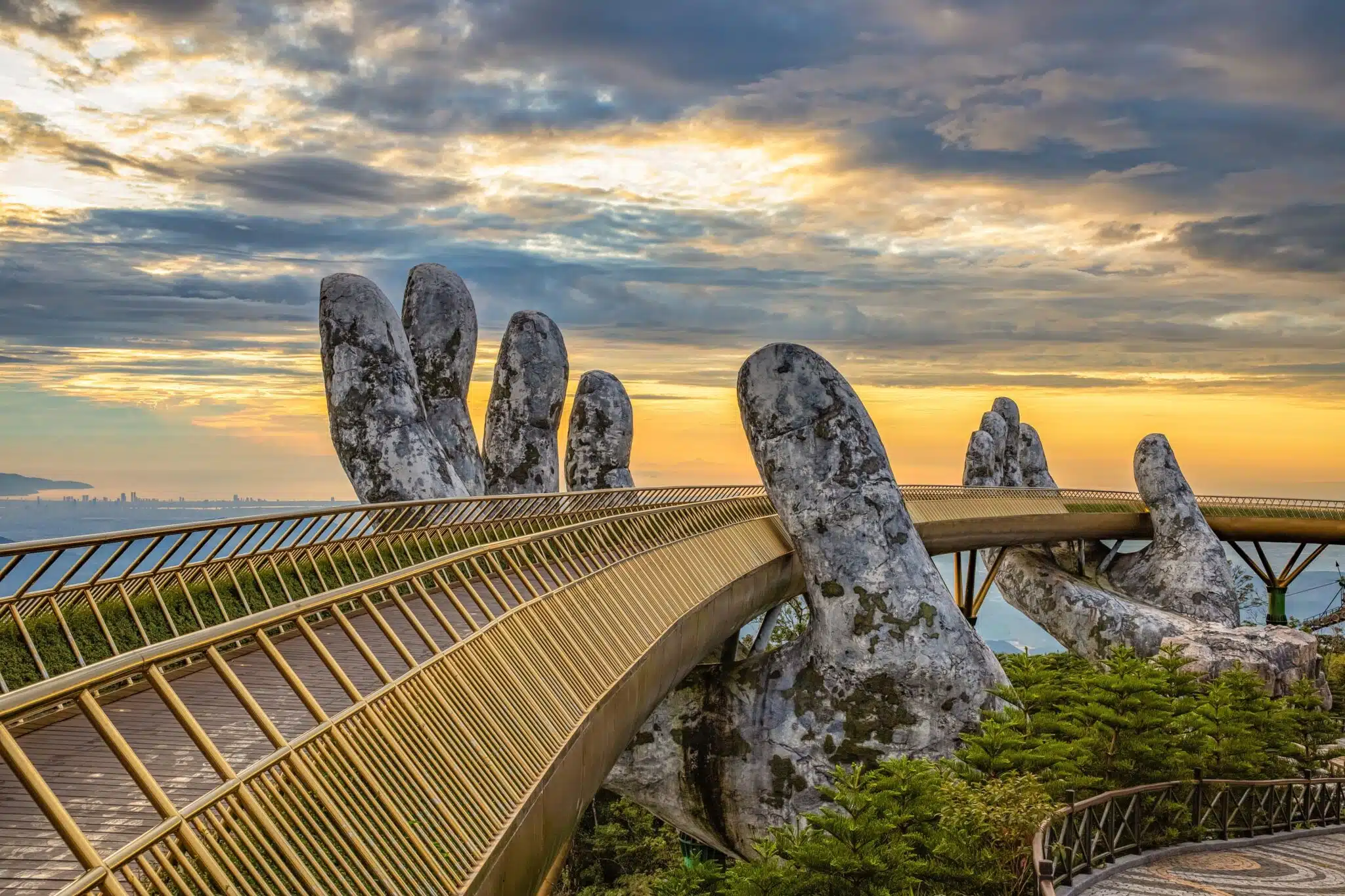 Aerial view of the Golden Bridge is lifted by two giant hands in the tourist resort on Ba Na Hill in Da Nang, Vietnam.