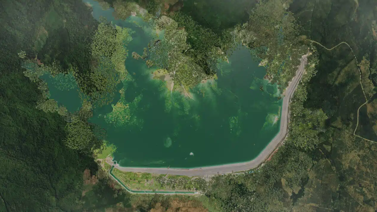 an arial photo of Semantok Dam showing the dam water surrounded by forest