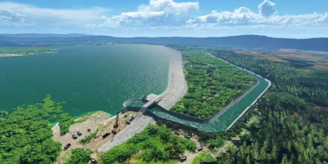 an arial photo of the Semantok Dam, with the dam water on the left and the forest on the right