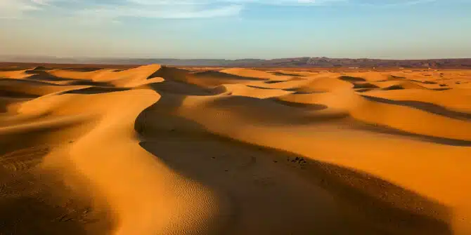 A ariel landscape photo with sand dunes in Sahara desert